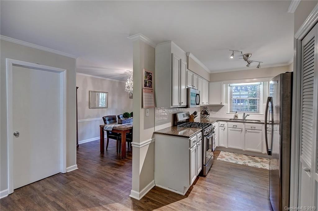 3508 Colony Road, Unit F Charlotte, NC 28211 - Photo 8 of 26 a kitchen with a sink cabinets and wooden floor