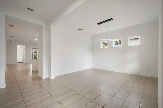 an empty room with windows and bathroom