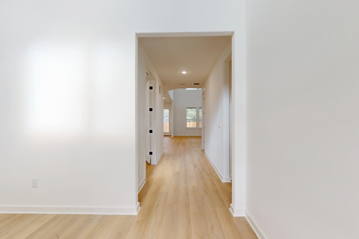 3913 Waxahachie Road Leander, TX 78641 - Photo 16 of 39 a view of a hallway with wooden floor