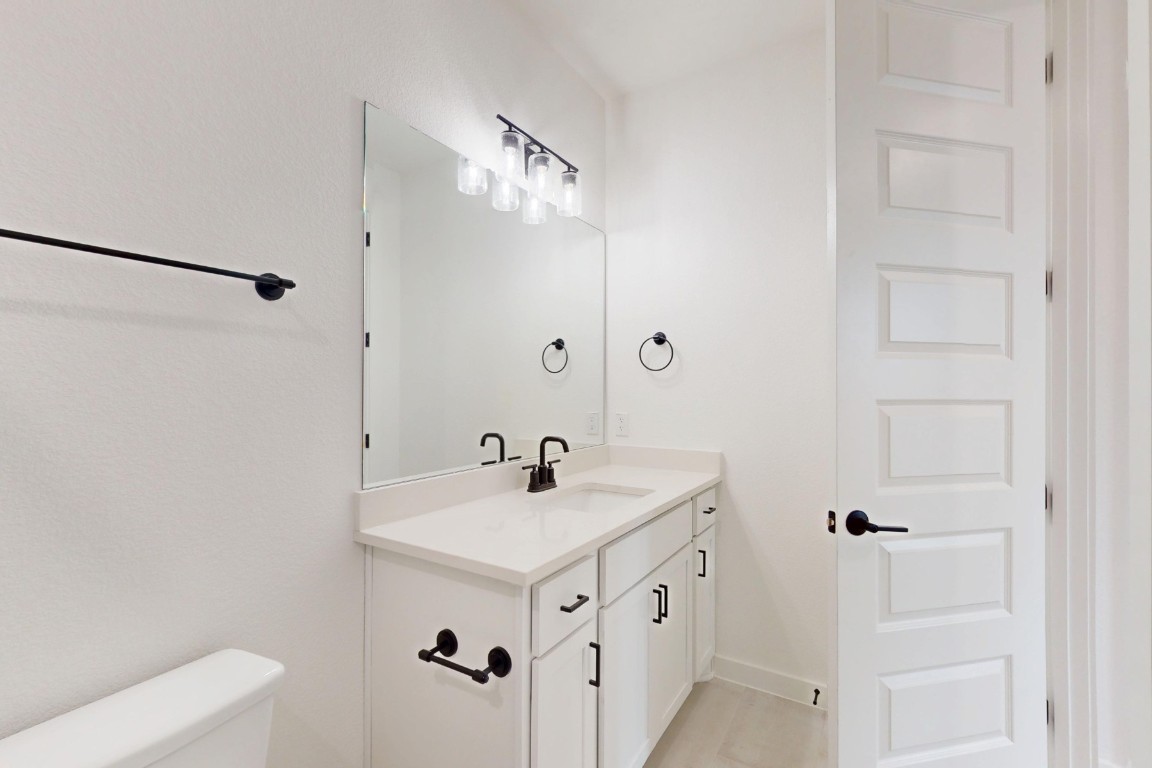 3913 Waxahachie Road Leander, TX 78641 - Photo 27 of 39 a bathroom with a sink a mirror and a shower