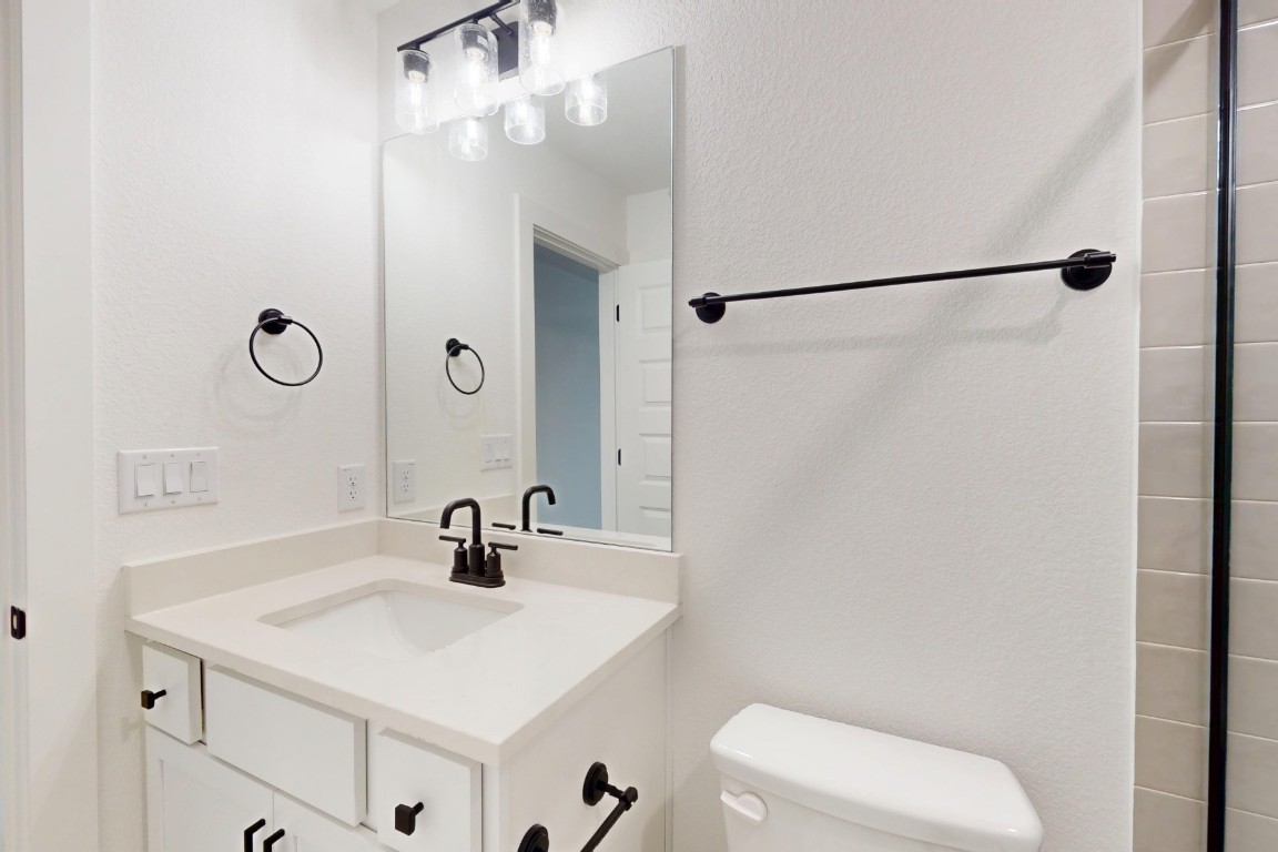 3913 Waxahachie Road Leander, TX 78641 - Photo 28 of 39 a bathroom with a sink toilet and shower