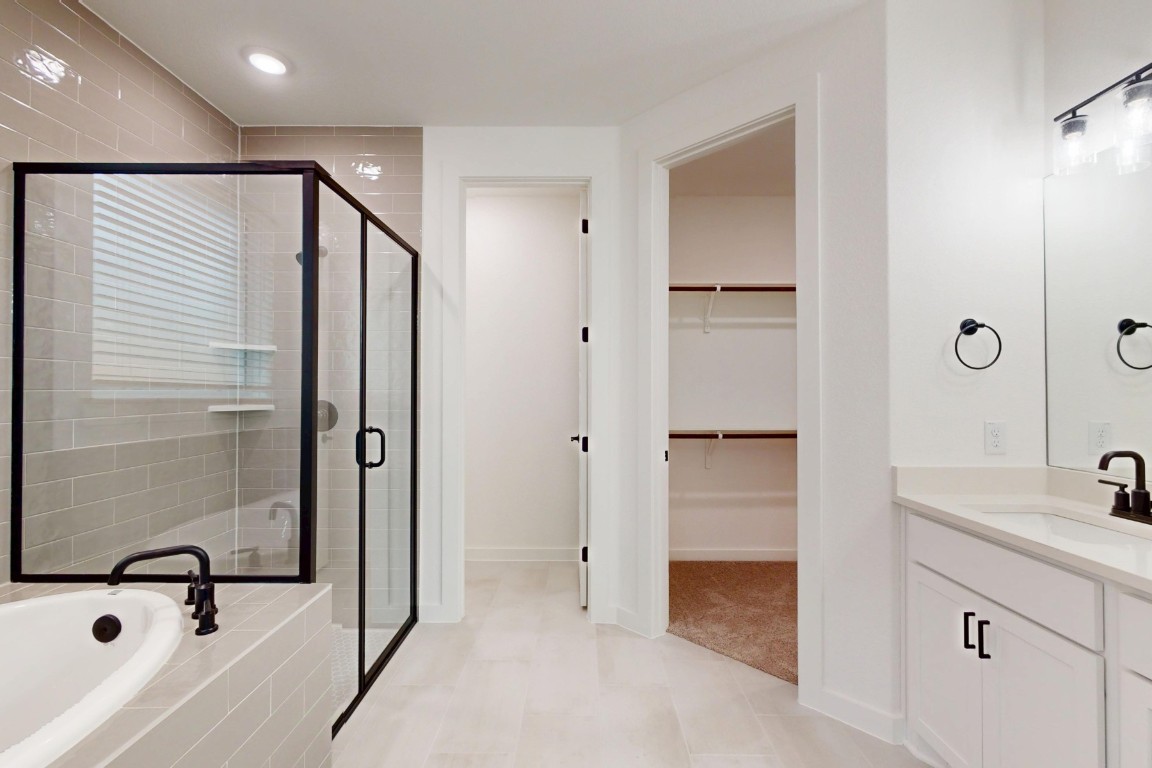 3913 Waxahachie Road Leander, TX 78641 - Photo 30 of 39 a bathroom with a tub and a sink