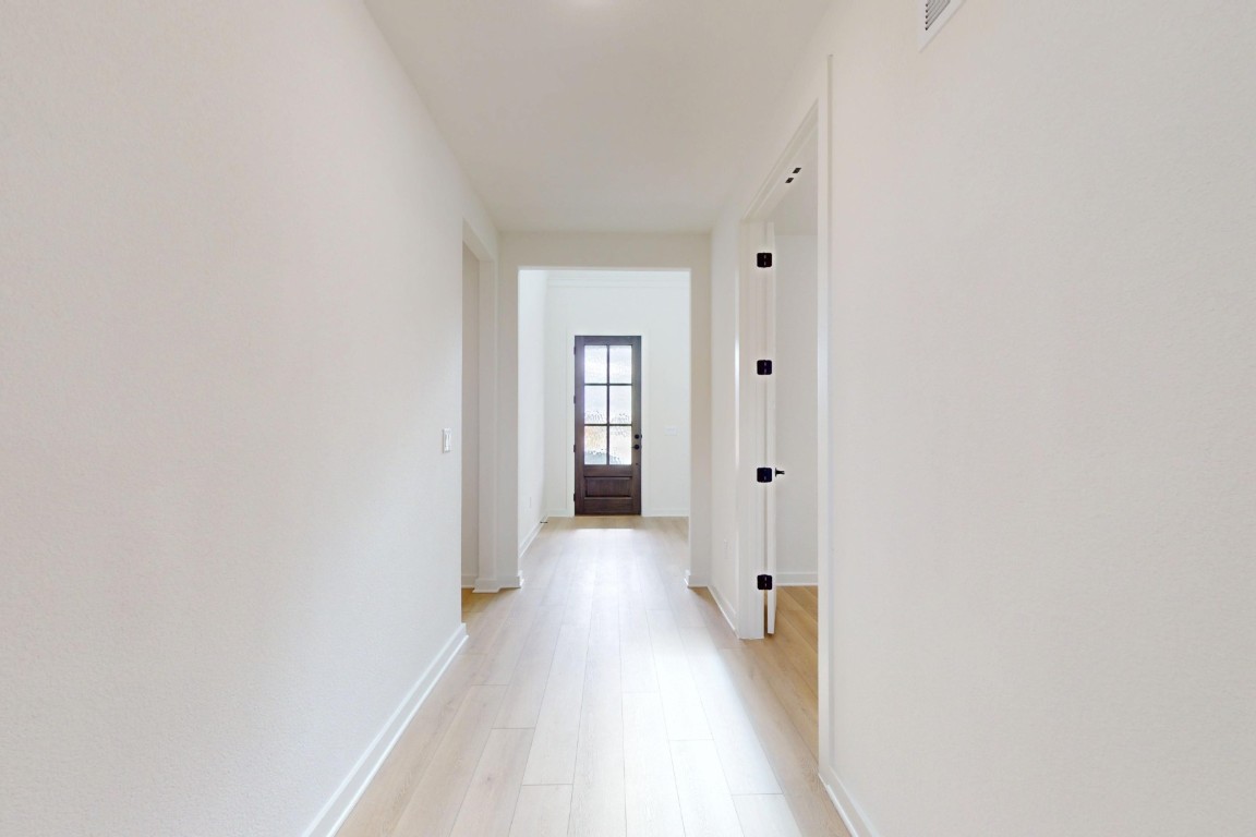 3913 Waxahachie Road Leander, TX 78641 - Photo 4 of 39 a view of a hallway with wooden floor
