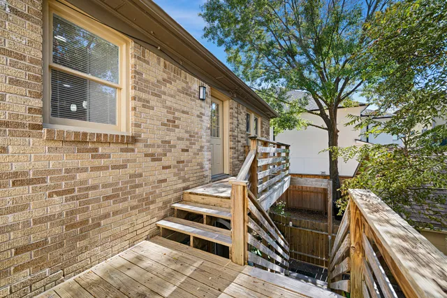 a view of a balcony with two chairs and a stove