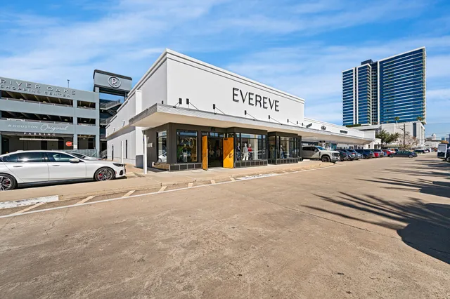 a view of a building with car parked
