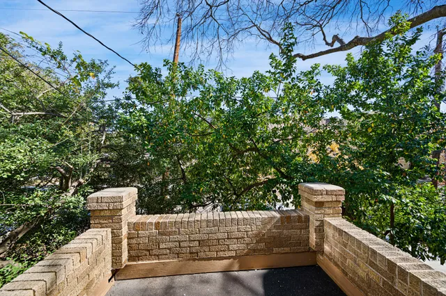 a wooden fence with some trees in the background