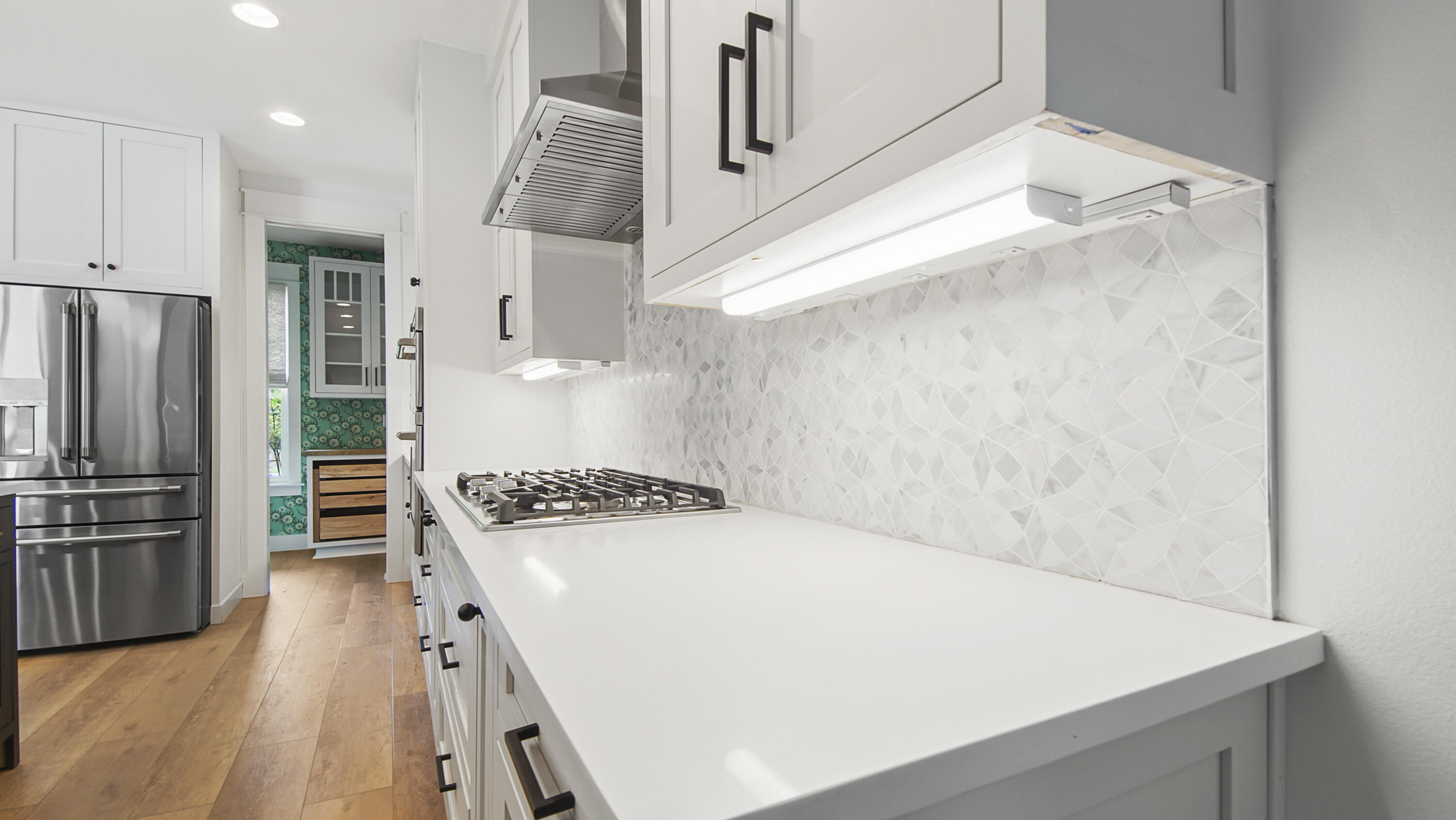 515 Hideaway Circle Santa Rosa Beach, FL 32459 - Photo 12 of 64 a kitchen with white cabinets and stainless steel appliances