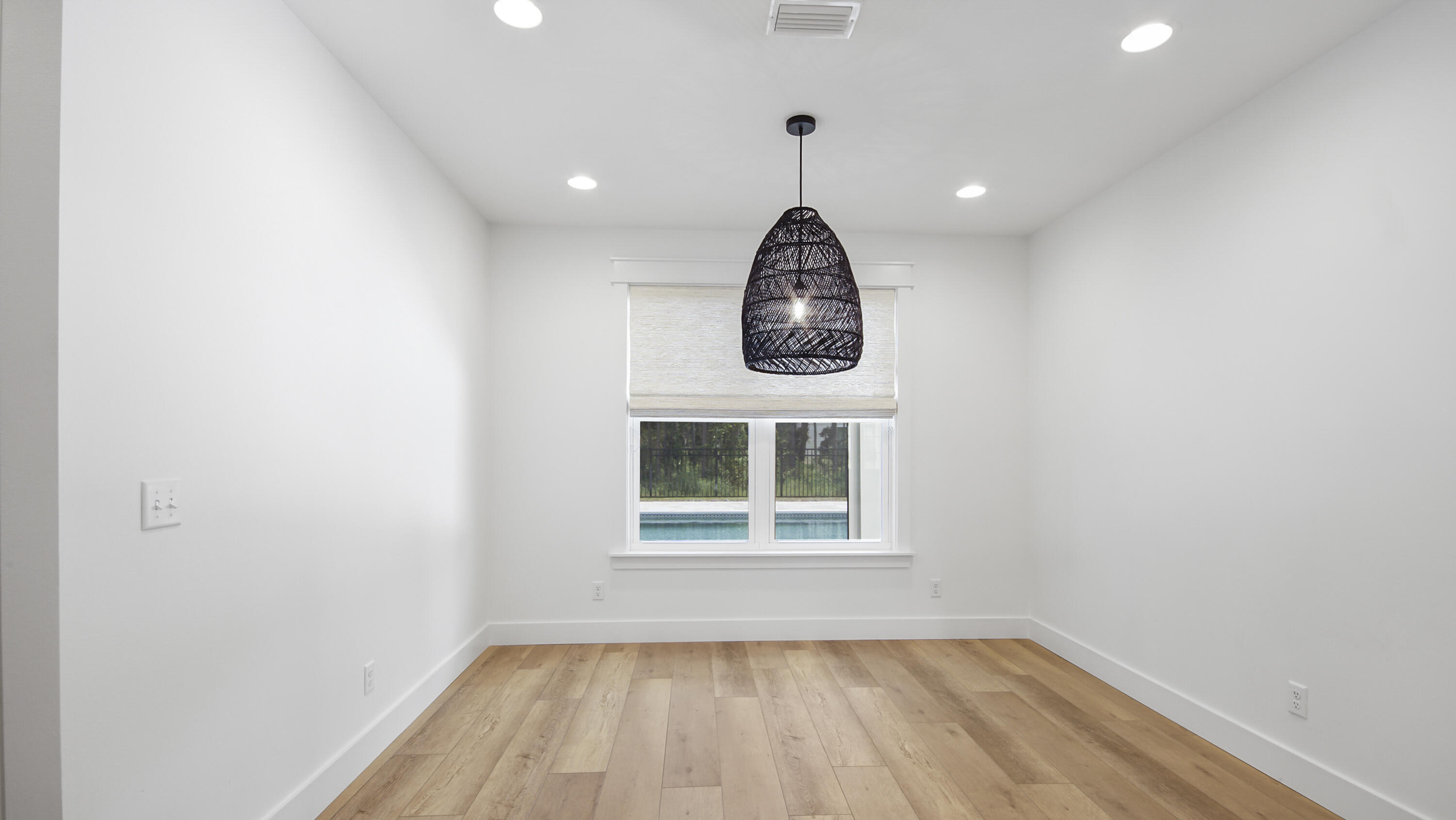 515 Hideaway Circle Santa Rosa Beach, FL 32459 - Photo 13 of 64 an empty room with wooden floor and windows