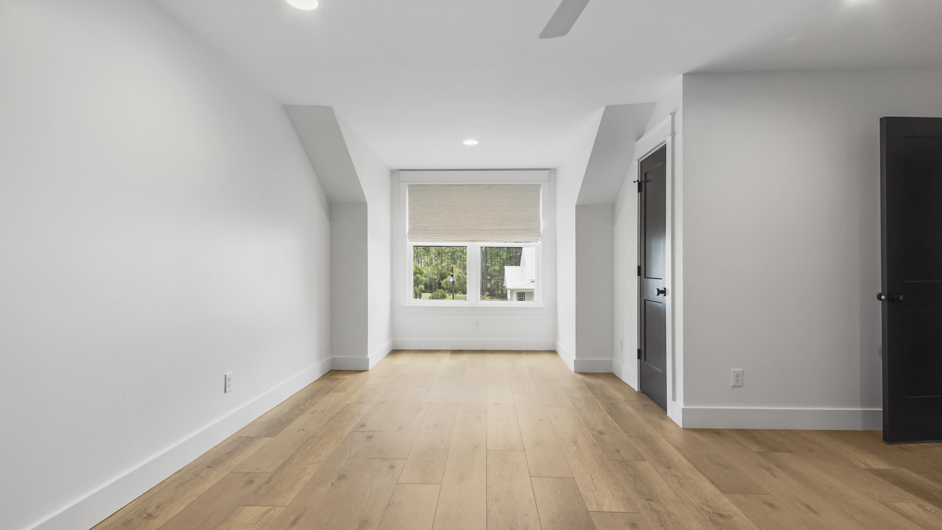 515 Hideaway Circle Santa Rosa Beach, FL 32459 - Photo 41 of 64 a view of an empty room with wooden floor and a window