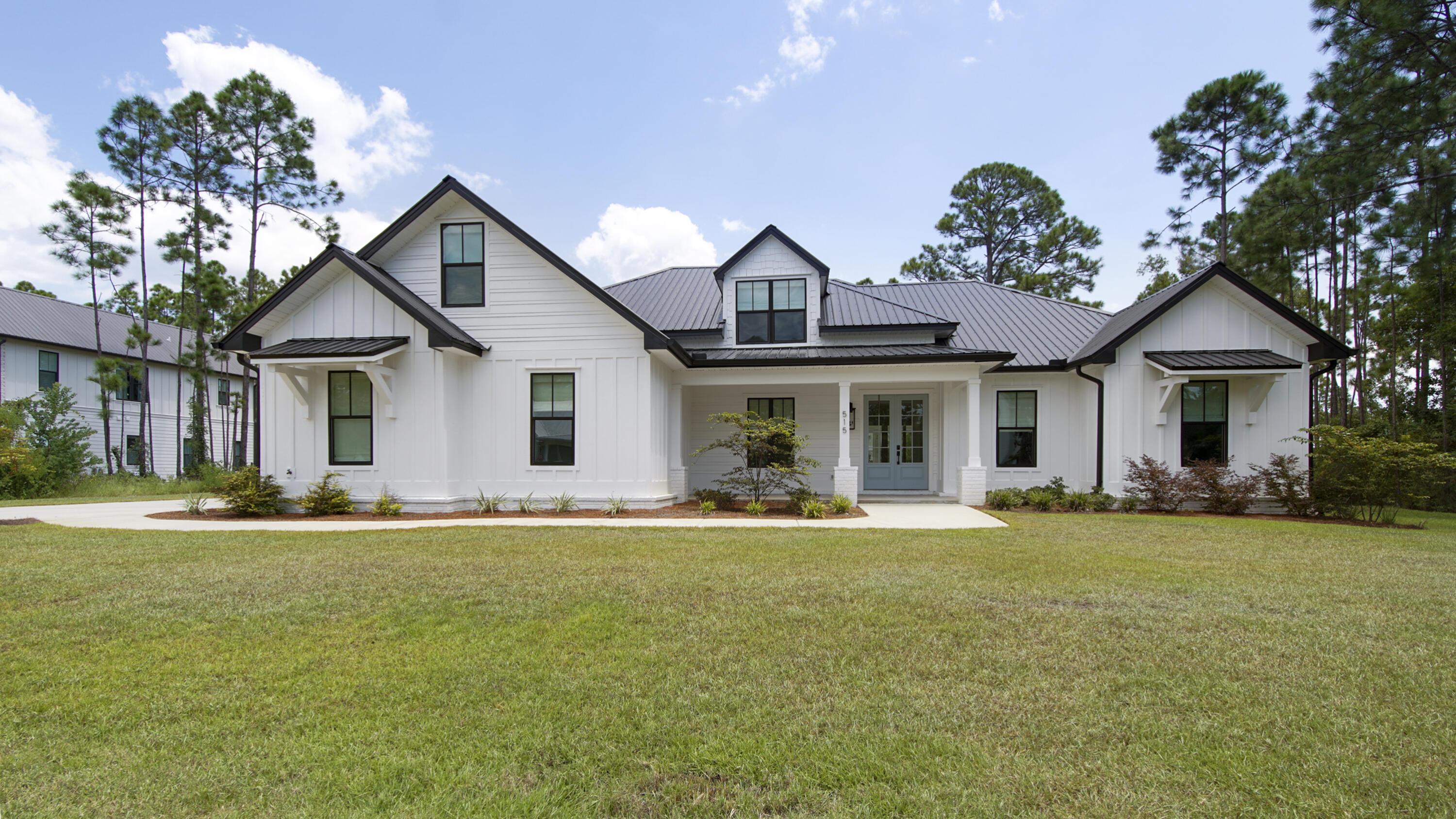 515 Hideaway Circle Santa Rosa Beach, FL 32459 - Photo 60 of 64 a front view of a house with a garden and yard