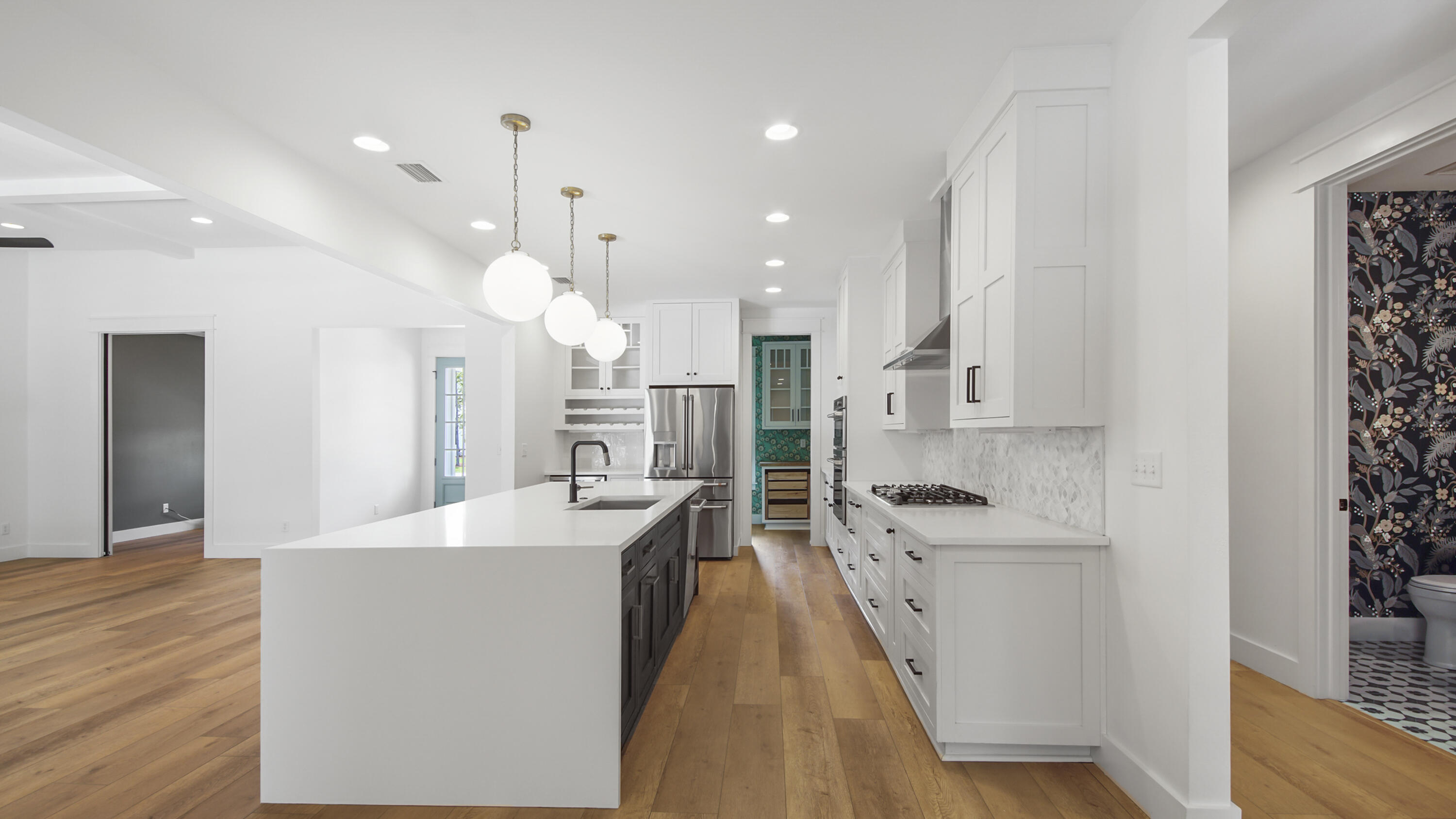 515 Hideaway Circle Santa Rosa Beach, FL 32459 - Photo 9 of 64 a large kitchen with kitchen island a stove a sink a center island and wooden floor