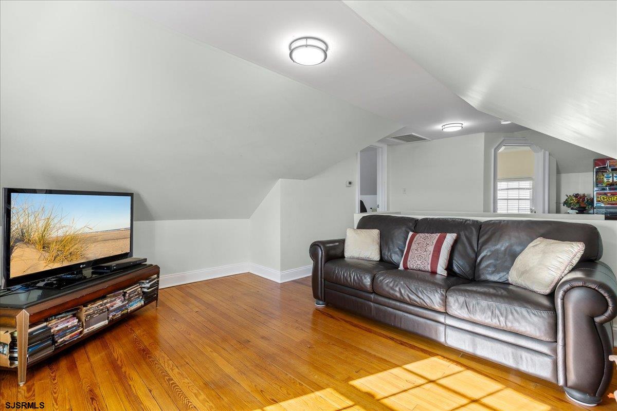 104 South Oakland Avenue, Unit JULY '26 Ventnor City, NJ 08406 - Photo 33 of 57 a living room with furniture and a flat screen tv