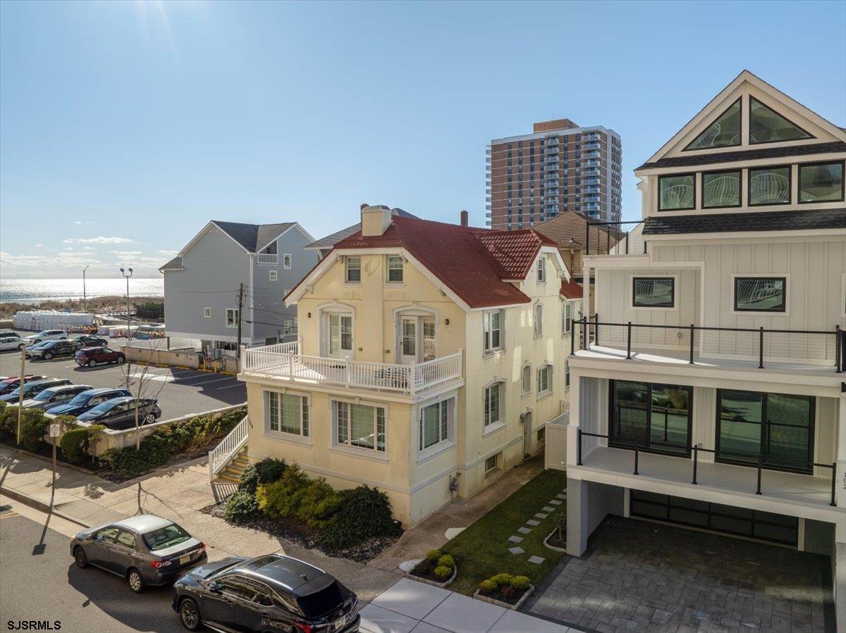 104 South Oakland Avenue, Unit JULY '26 Ventnor City, NJ 08406 - Photo 56 of 57 a view of a big building with cars parked in front of it