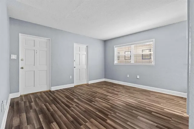 a view of a room with wooden floor and furniture
