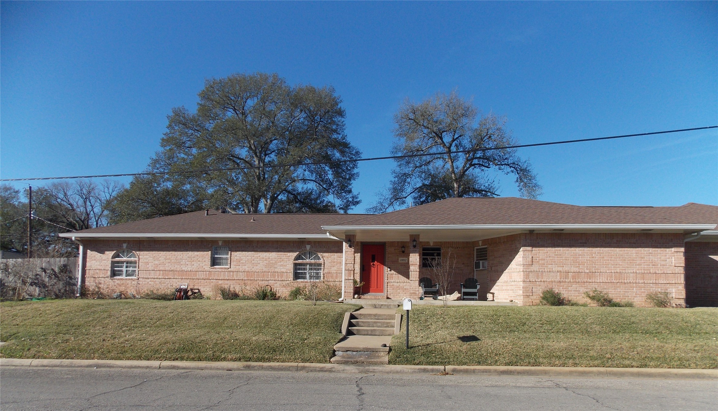 1002 Washington Street Brenham, TX 77833 - Photo 1 of 25 front view of a house with a porch