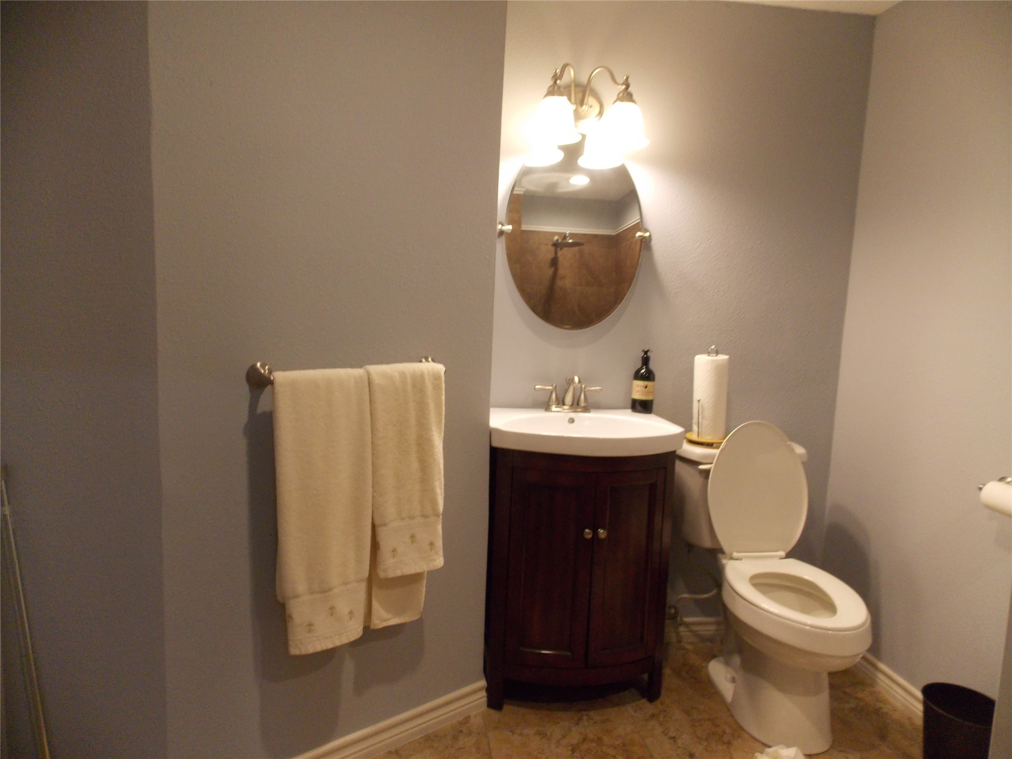 1002 Washington Street Brenham, TX 77833 - Photo 12 of 25 a bathroom with a toilet sink and mirror
