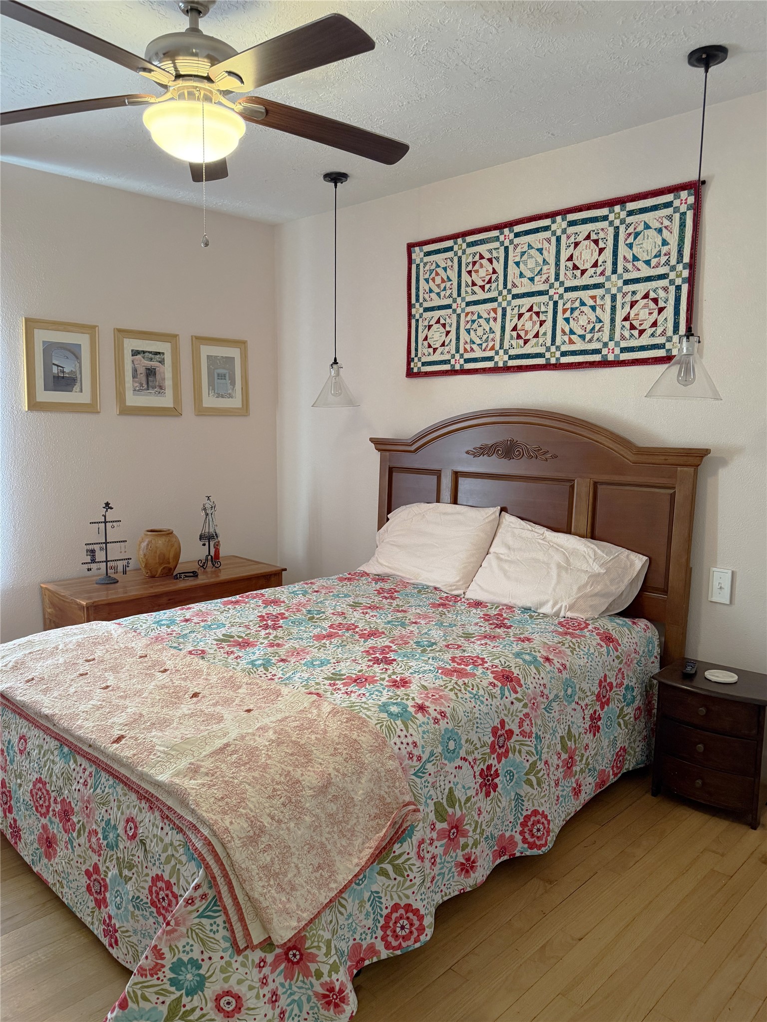 1002 Washington Street Brenham, TX 77833 - Photo 14 of 25 a bedroom with a bed and a chandelier