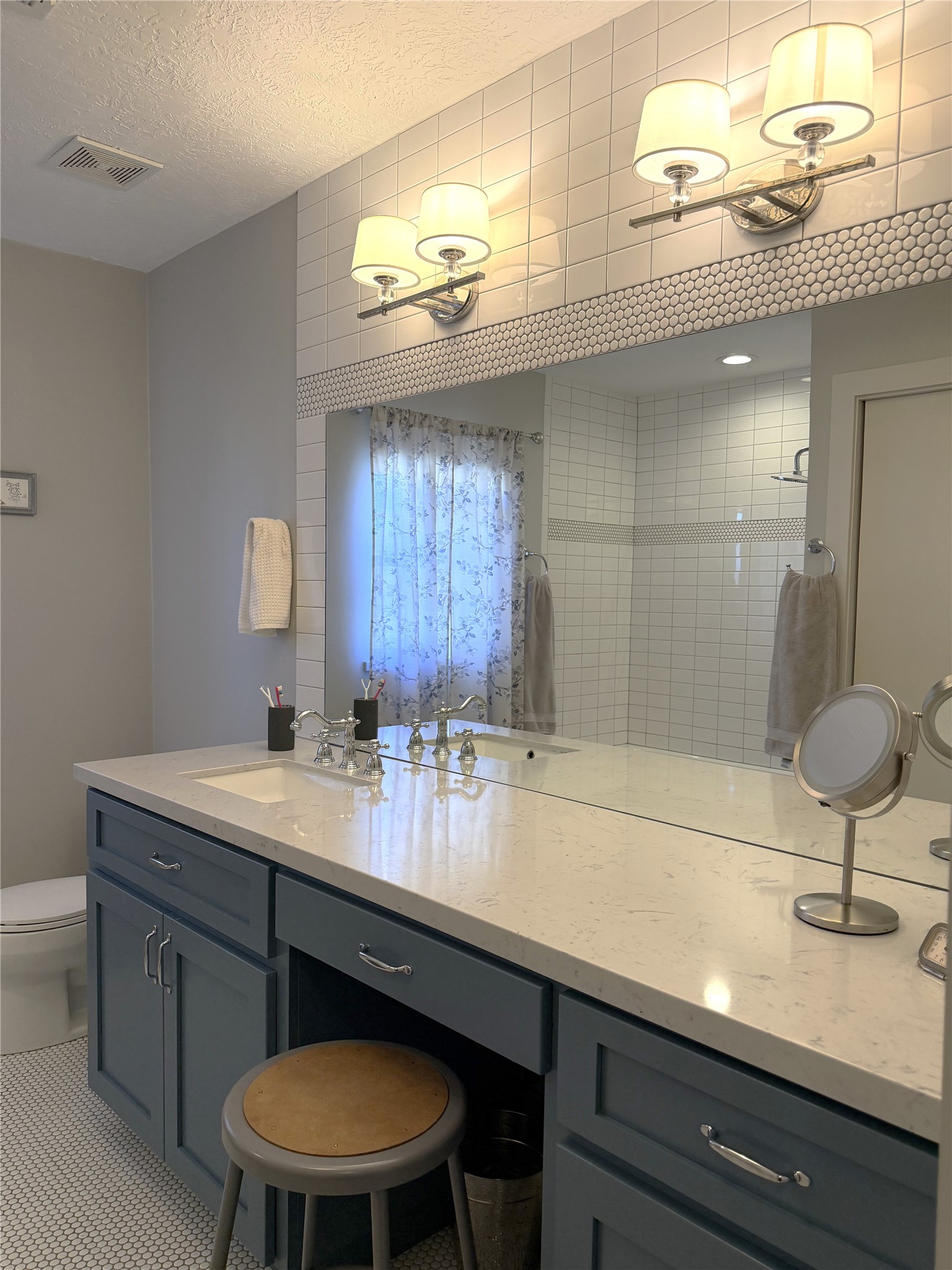 1002 Washington Street Brenham, TX 77833 - Photo 17 of 25 a bathroom with a sink a large mirror and a toilet