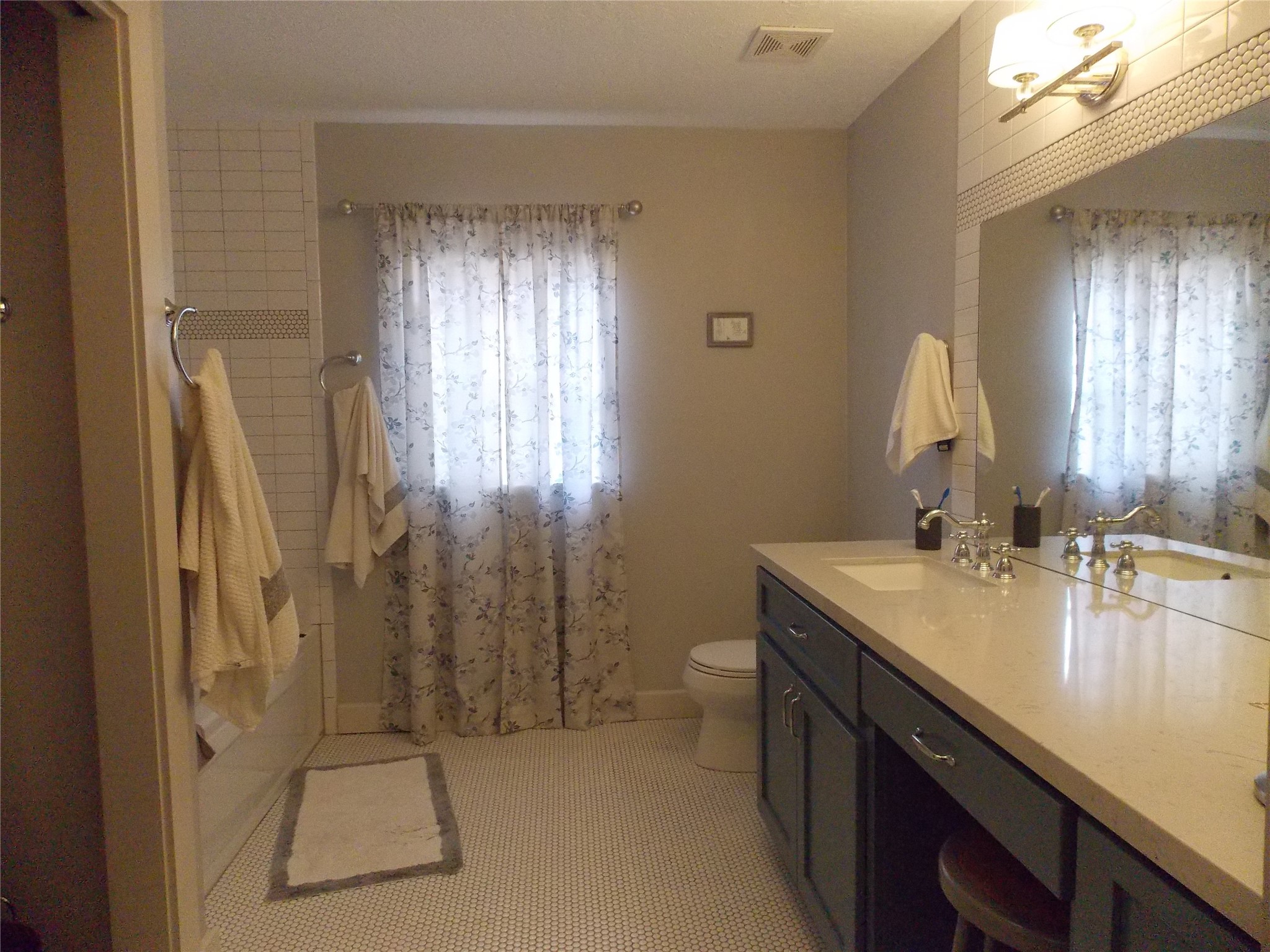 1002 Washington Street Brenham, TX 77833 - Photo 18 of 25 a bathroom with a sink a toilet and shower