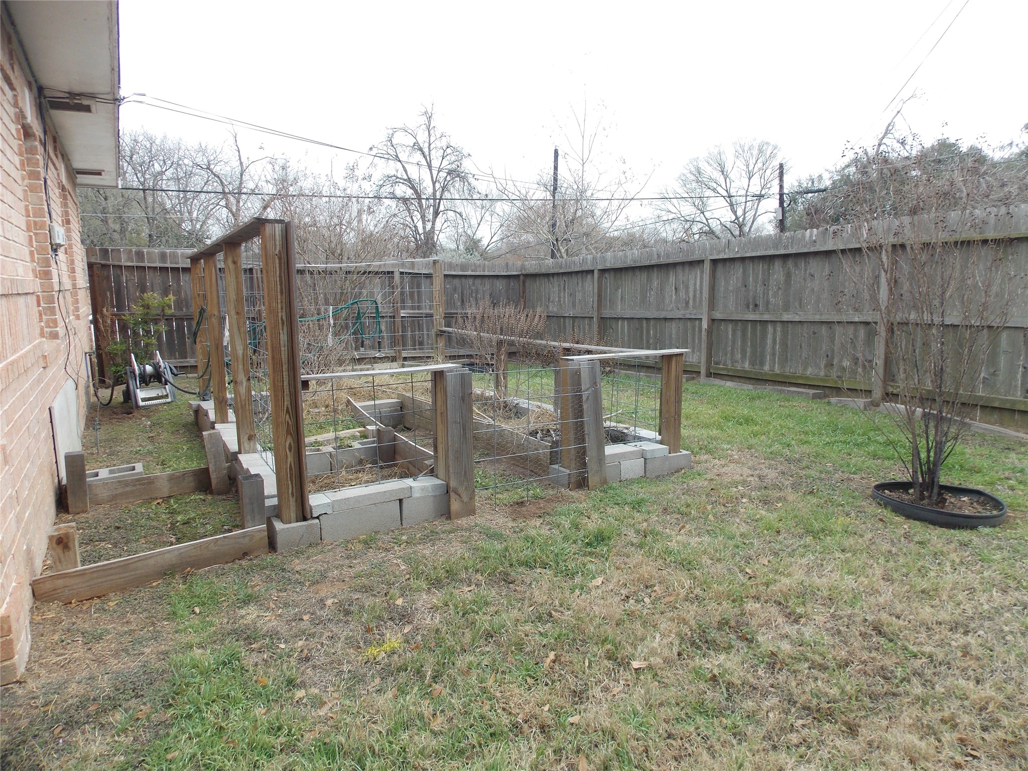 1002 Washington Street Brenham, TX 77833 - Photo 25 of 25 a view of a backyard with wooden fence