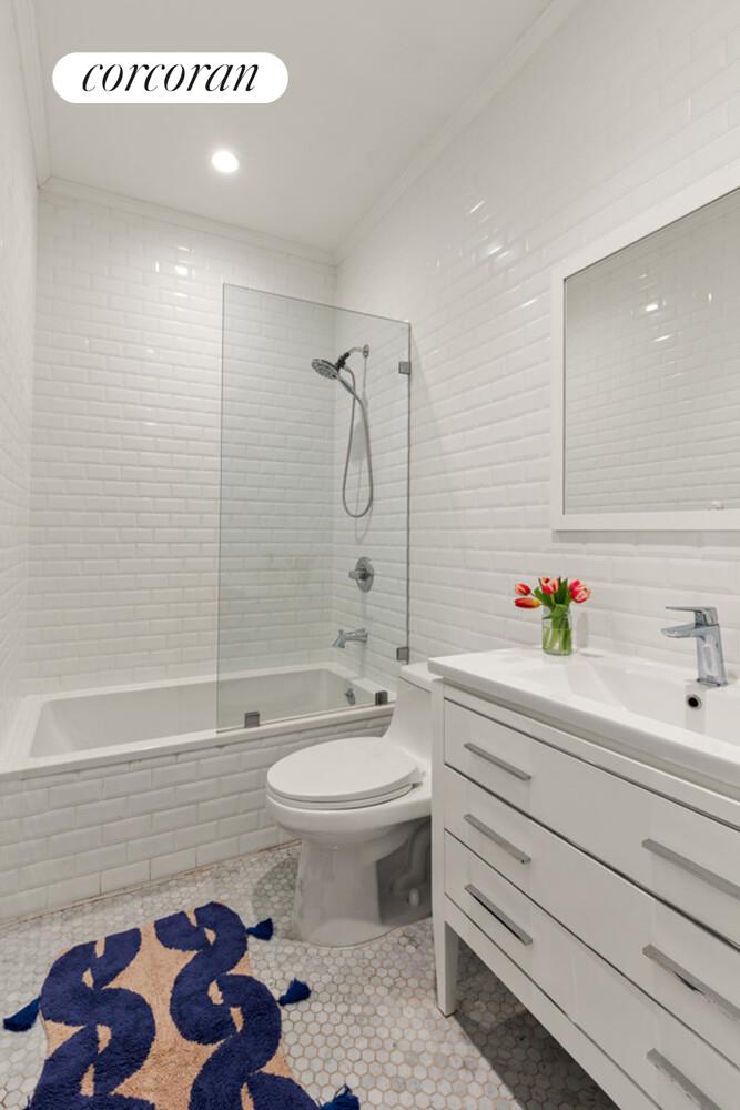 1079 Hancock Street Brooklyn, NY 11221 - Photo 14 of 22 a bathroom with a sink a toilet and a bathtub