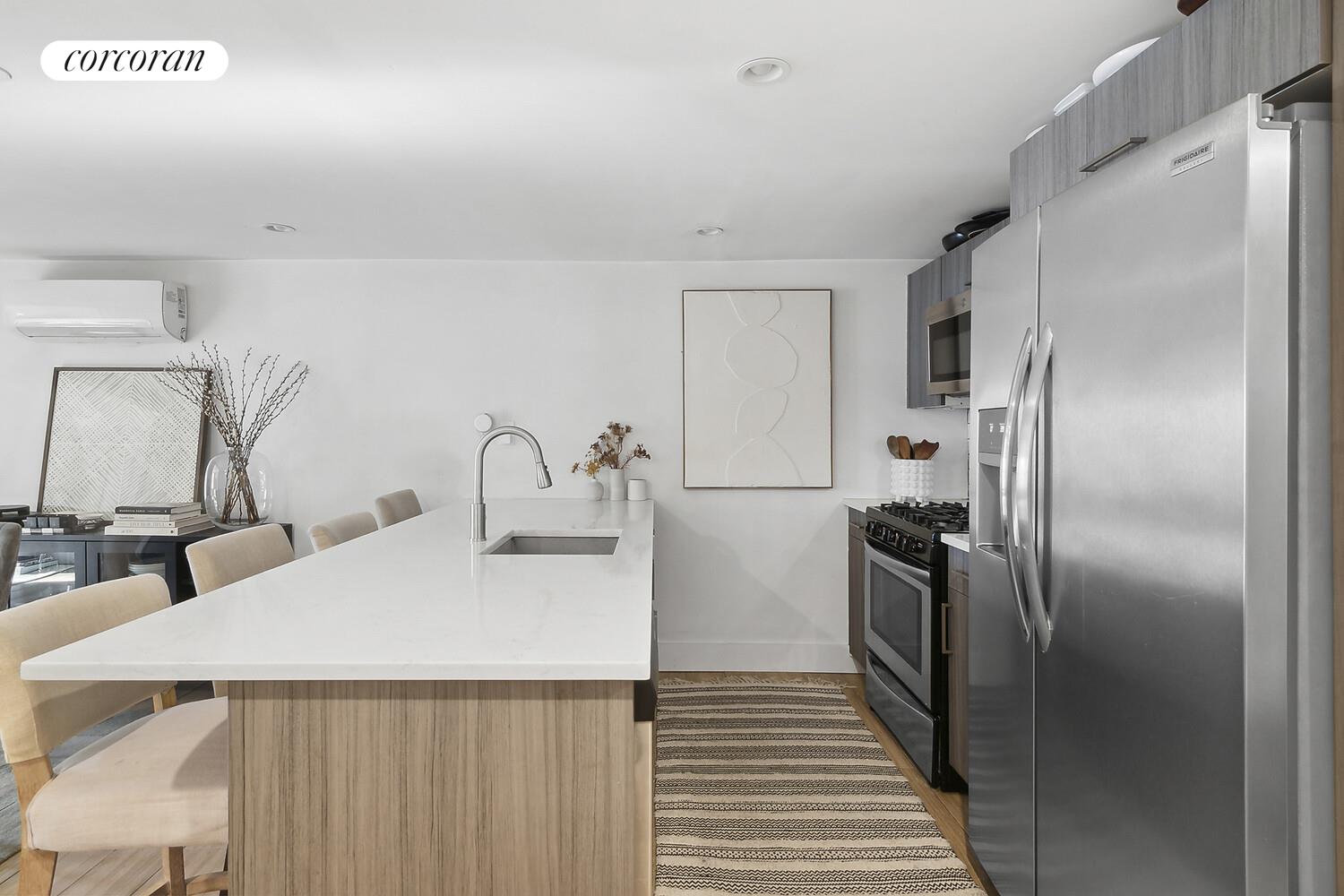 1079 Hancock Street Brooklyn, NY 11221 - Photo 16 of 22 a kitchen with stainless steel appliances a refrigerator sink and cabinets