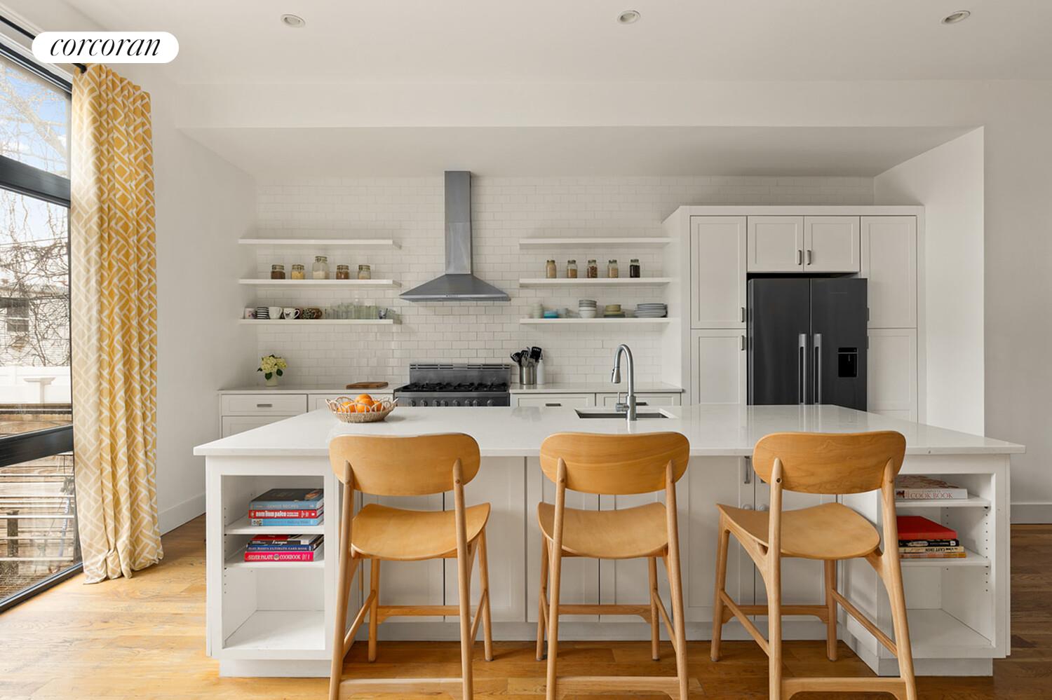 1079 Hancock Street Brooklyn, NY 11221 - Photo 6 of 22 a dining room with stainless steel appliances a table and chairs in it