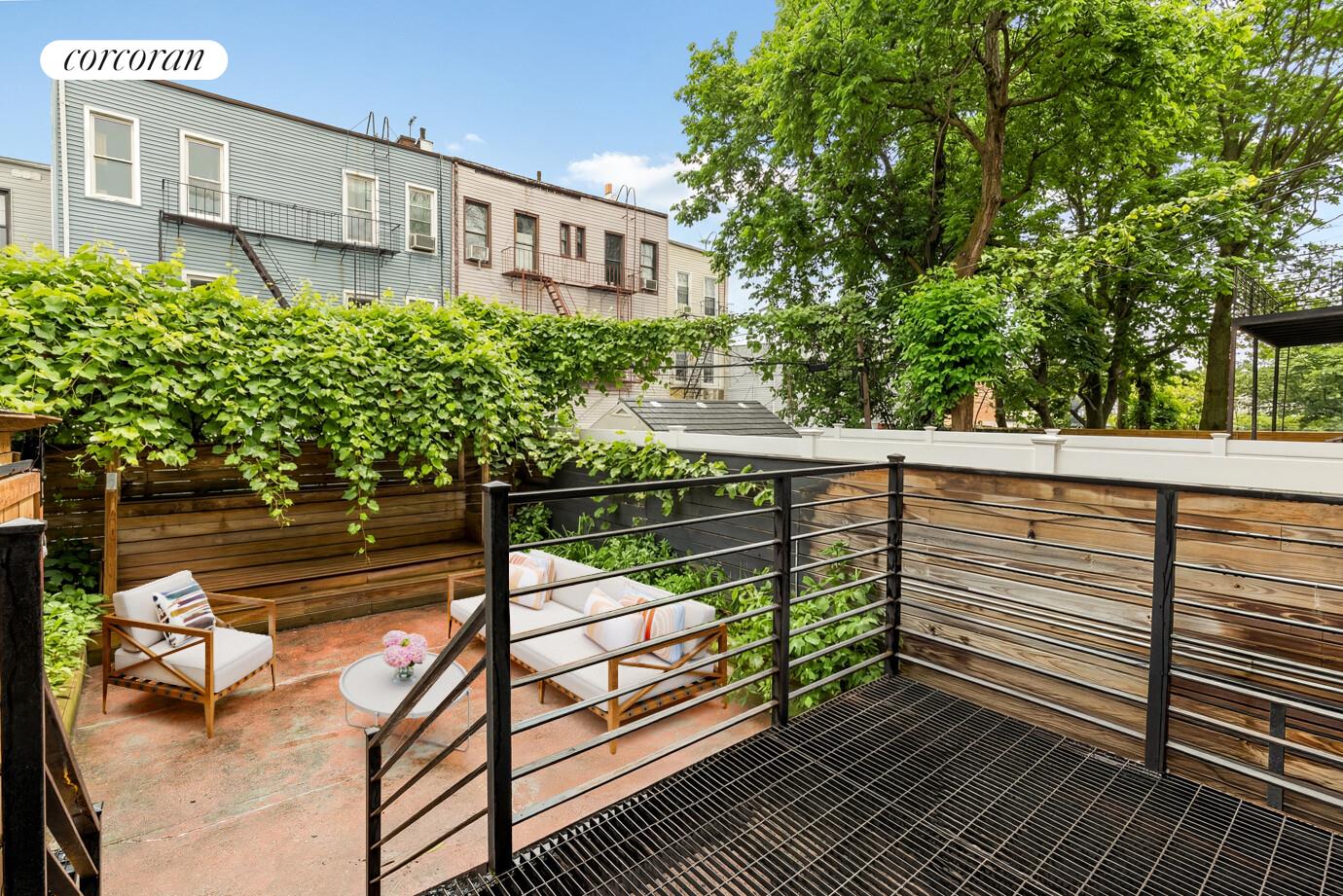 1079 Hancock Street Brooklyn, NY 11221 - Photo 7 of 22 a view of a roof deck with wooden floor and fence next to a yard