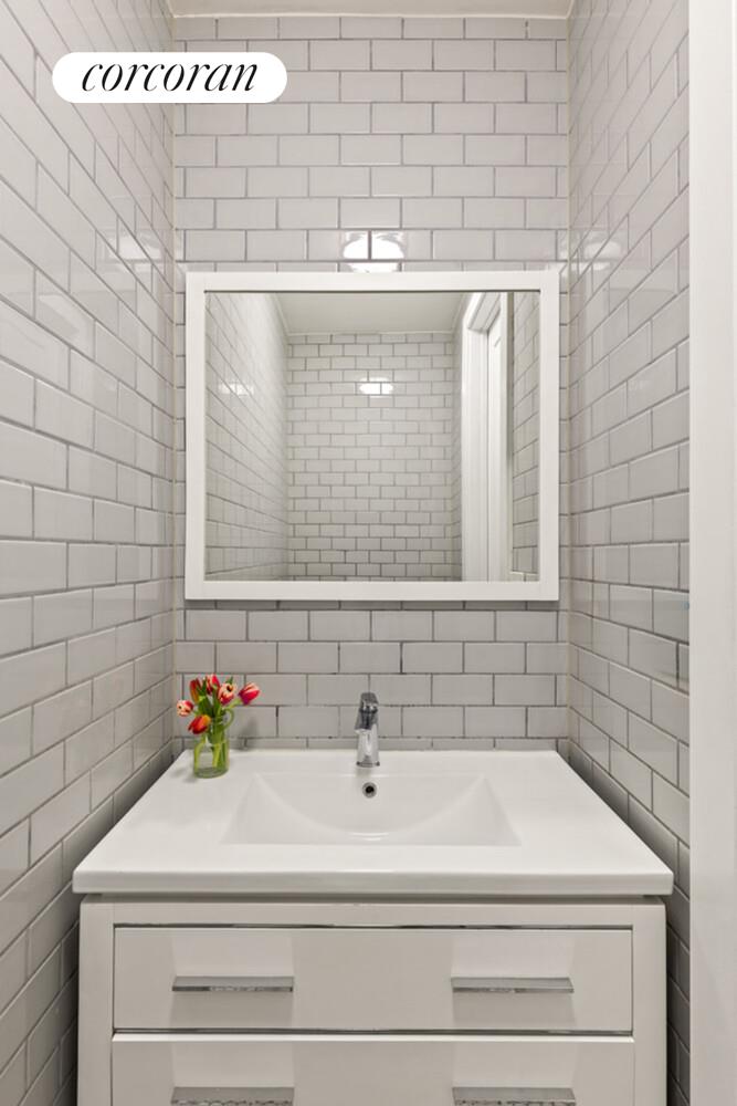 1079 Hancock Street Brooklyn, NY 11221 - Photo 8 of 22 a bathroom with a bathtub and shower