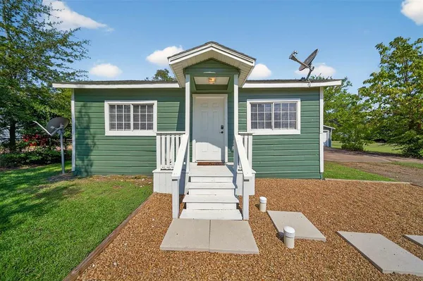a front view of a house with a yard and porch