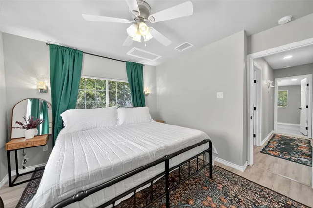a large bed sitting in a bedroom next to a window
