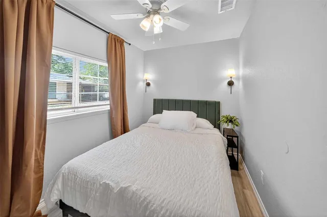 a bed sitting in a bedroom next to a window