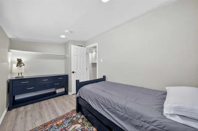 a bedroom with a bed and a dresser