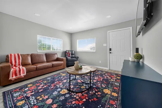 a living room with furniture and a rug