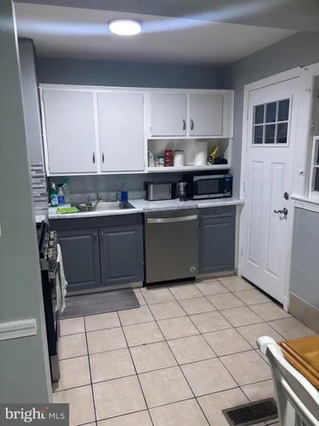a kitchen with stainless steel appliances a sink and a refrigerator