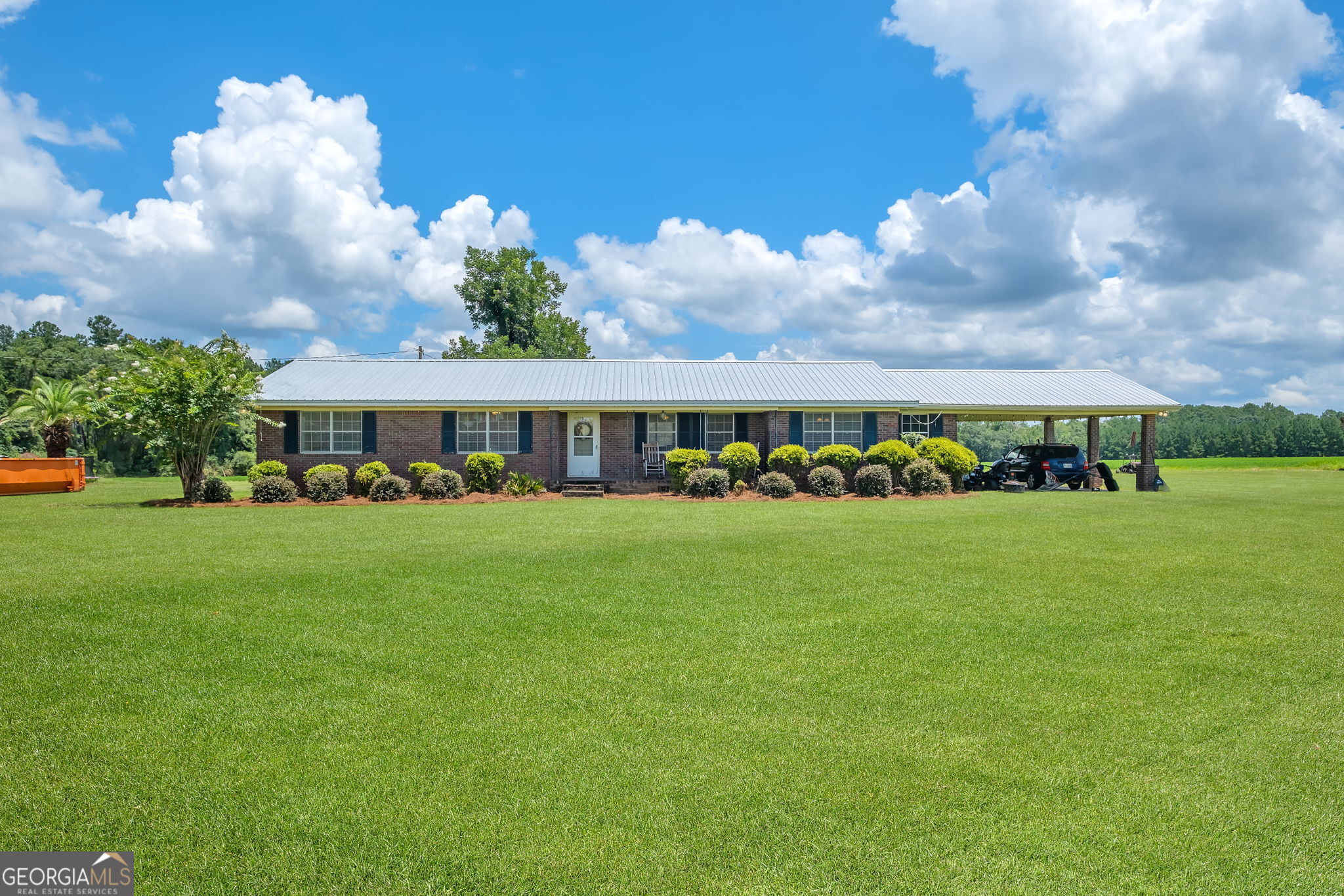 a front view of a house with garden