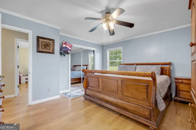 a spacious bedroom with a bed and a chandelier