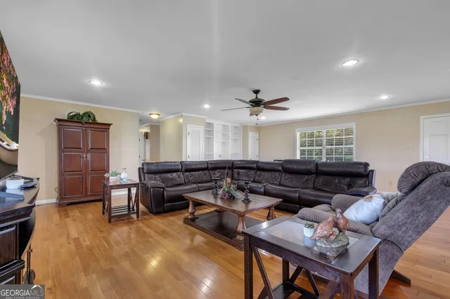 a living room with furniture and a pool table