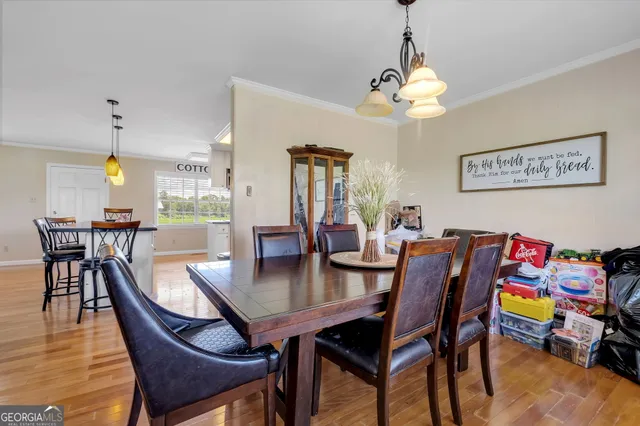 a view of a dining room with furniture and wooden floor