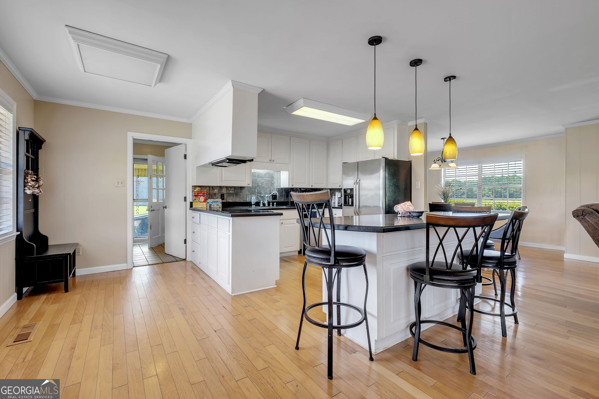 171 Council Lane Cairo, GA 39828 - Photo 24 of 44 a kitchen with stainless steel appliances granite countertop wooden floor dining table chairs and view living room