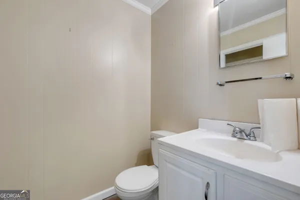 a bathroom with a sink a toilet and mirror