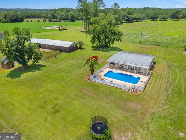 a view of a lake with a yard and outdoor seating
