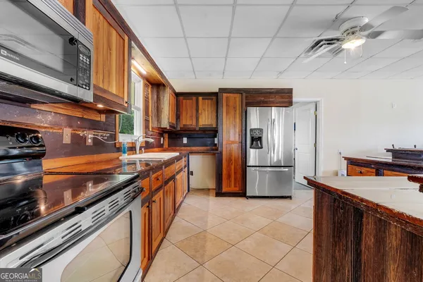 a kitchen with stainless steel appliances granite countertop a stove a refrigerator and a sink