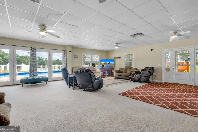 a spacious bedroom with a bed a couch and a large window