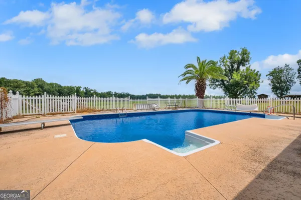 a view of a swimming pool with a lounge chair
