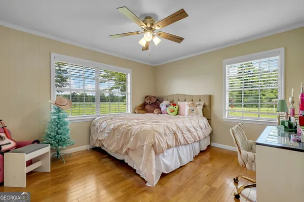 a spacious bedroom with a bed and a large window