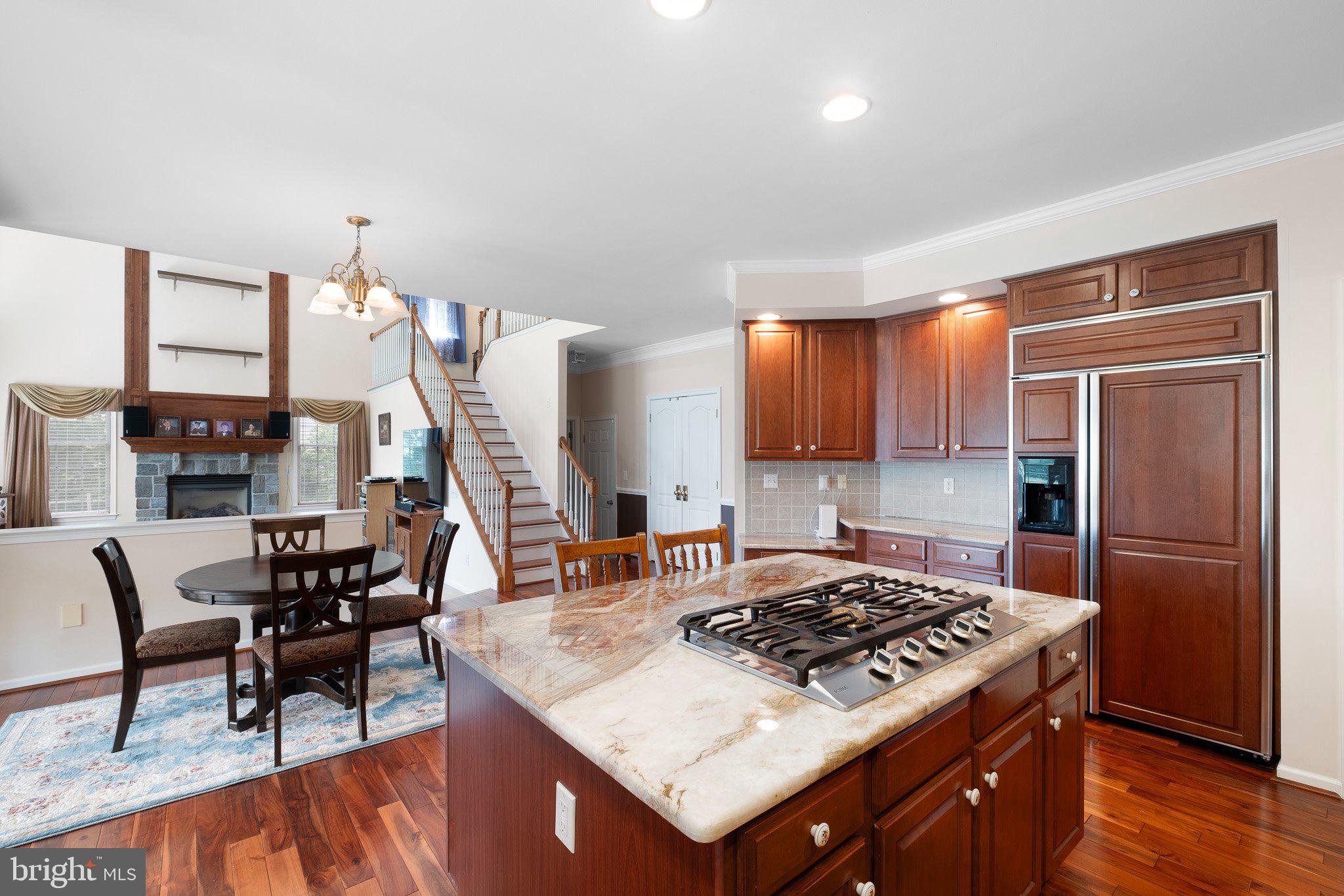 407 Nattull Drive Bear, DE 19701 - Photo 11 of 65 a kitchen with stainless steel appliances granite countertop a stove refrigerator and chairs
