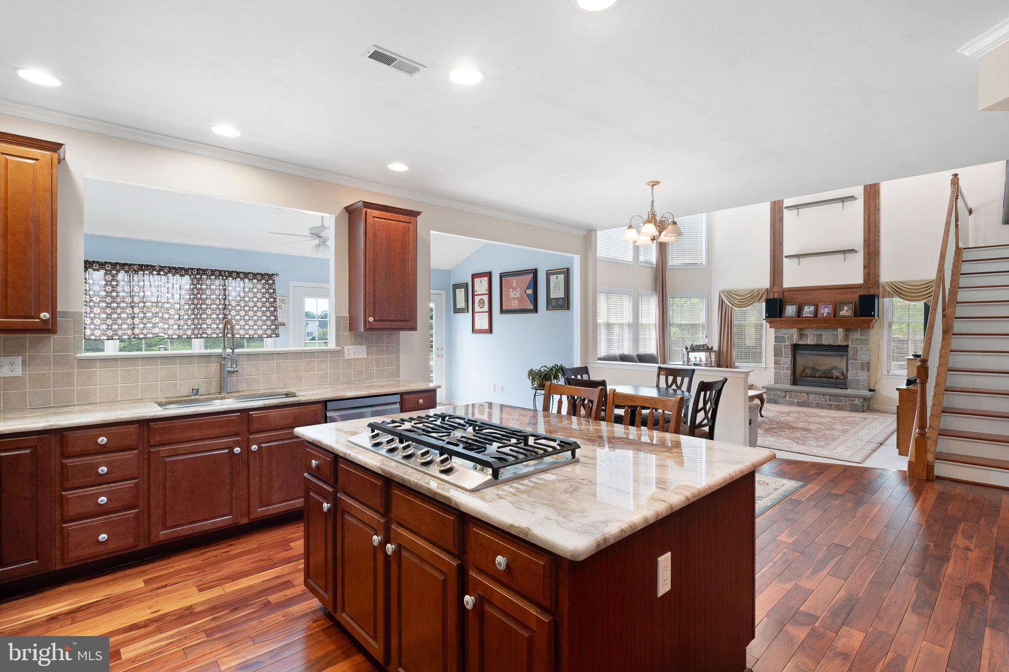 407 Nattull Drive Bear, DE 19701 - Photo 12 of 65 a kitchen with granite countertop a sink stove and cabinets