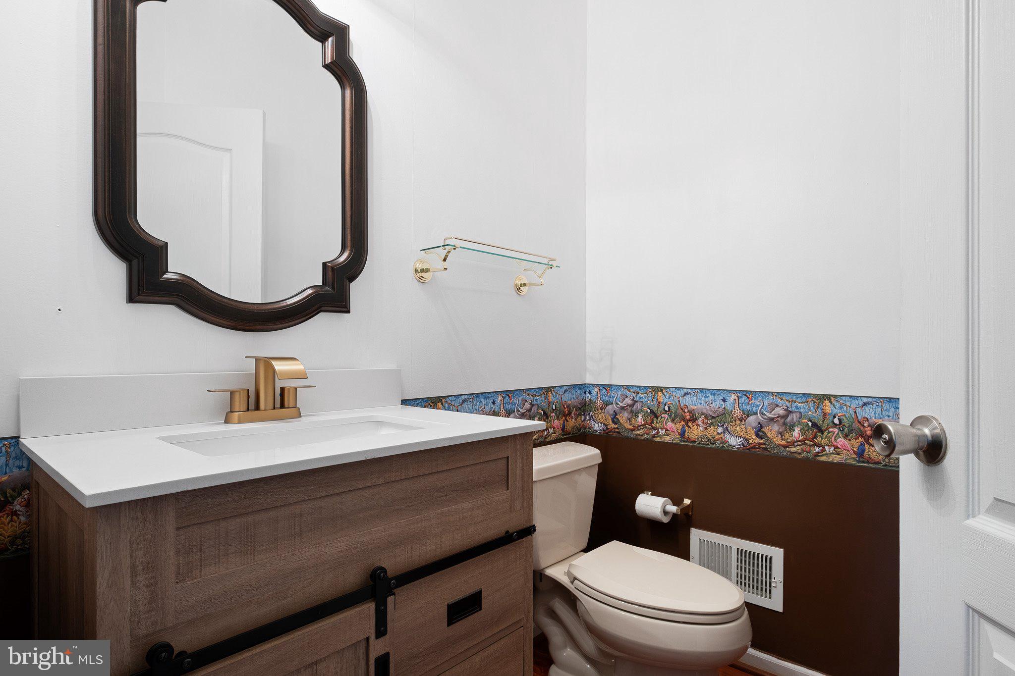 407 Nattull Drive Bear, DE 19701 - Photo 21 of 65 a bathroom with a sink vanity mirror and toilet