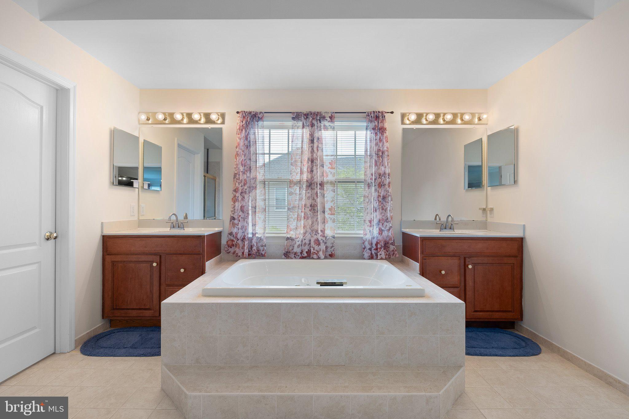407 Nattull Drive Bear, DE 19701 - Photo 29 of 65 a spacious bathroom with a tub sink and mirror
